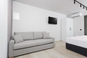 a living room with a couch and a bed at Rigas Boutique Rooms in Pefkochori