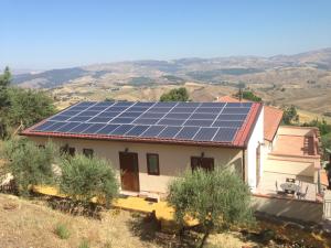 a house with solar panels on top of it at B&B Profumi di Sicilia in San Cataldo