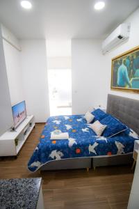 Ένα ή περισσότερα κρεβάτια σε δωμάτιο στο El Prado Suites Alojamiento