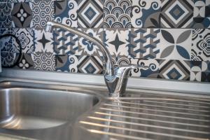 a sink with a faucet in a kitchen at Theramvos Superior Apartments in Hanioti +67 photos