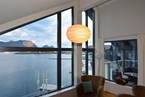 a room with a large window with a view of the water at Hamn i Senja in Hamn