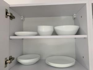 a kitchen with two toilets and bowls on shelves at Apartamenty Trawers in Wielen Zaobrzanski