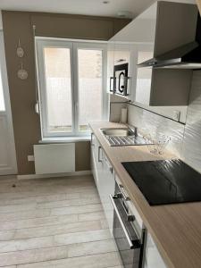 a kitchen with a sink and a counter top at Maison centre ville Ardres in Ardres