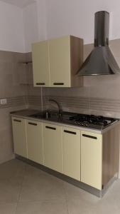a kitchen with a sink and a stove at Appartamenti da Matteo in Peschici +4 photos