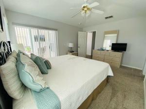 a bedroom with a large bed and a ceiling fan at Beautiful Southern Dunes Villa Golf Course Views in Haines City