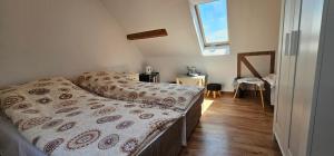 a small bedroom with two beds and a window at Keja in Łeba