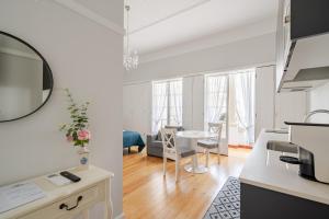 a kitchen and a living room with a table at Suites do Doutor in Pombal