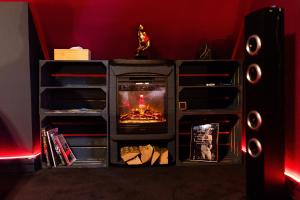a fireplace with a fire in it in a room at Urban Spa 3 nuances de plaisir in Troyes