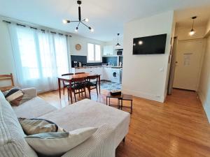 a living room with a couch and a table at L'appart du Maupas, T3, wifi, parking in Luchon