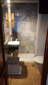 a bathroom with a sink and a toilet at La guarida delChorro in Málaga