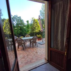 an open door to a patio with a table and chairs at Casa Ugo in Poppi +20 photos