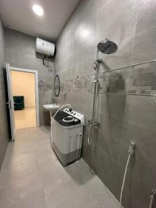 a bathroom with a shower and a sink at شقق مفروشة صلالة - Furnished Apartments Salalah in Salalah