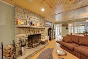 a living room with a large stone fireplace at Creekside Newland Cabin about 7 Mi to Linville Falls in Newland