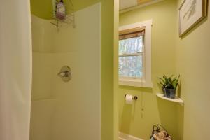 a bathroom with green walls and a window at Creekside Newland Cabin about 7 Mi to Linville Falls in Newland +26 photos