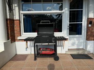 a grill with a laptop on top of it in front of a door at la villa dewez a loverval in Gerpinnes