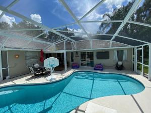 a large swimming pool with a glass roof at Fully Updated Pool Villa Southern Dunes in Haines City