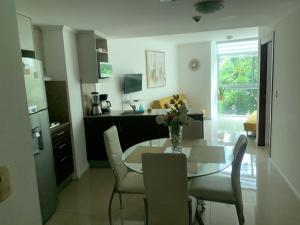 una cucina e una sala da pranzo con tavolo e sedie di Ecusuites Family Depto Resort Riverfront Gye a Guayaquil
