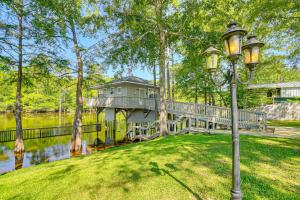 a street light in front of a house on the water at Private Boat Launch! Riverfront Jefferson Retreat in Jefferson