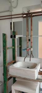 a bathroom with a white sink and a mirror at A Cascada do Ézaro in Dumbría +38 photos
