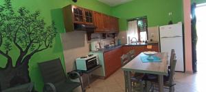 a kitchen with a table and a tree mural on the wall at Politimis house in Makrinára