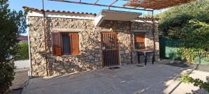 a stone house with a wooden door in a yard at Politimis house in Makrinára