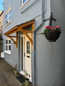 a door of a house with a flower pot on it at Cottage 33 in Kirkby Stephen