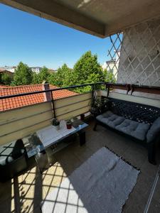 a balcony with a couch and a table at Apartament MaGiFa Constanța in Constanţa