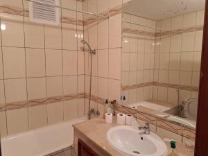 a bathroom with a sink and a tub and a mirror at Vue sur mer in El Harhoura +18 photos