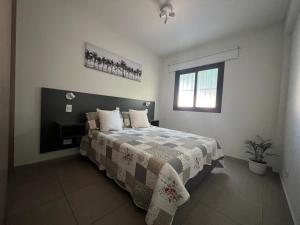 a bedroom with a bed and a window at Terra Malbec in Godoy Cruz