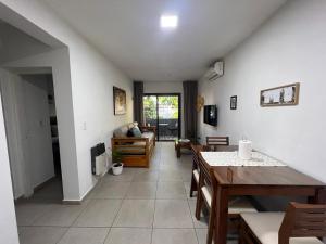 a living room with a table and a couch at Terra Malbec in Godoy Cruz