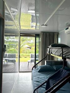 a bedroom with a bunk bed and a patio at Furnished Modern Farm Flat Tuvurara Savusavu Jasmeeruls Bayt in Nakasa