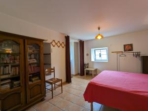 a bedroom with a bed and a book shelf at Charmant gîte en Berry avec terrasses, jardin et parking privé, proche de Nohant et La Châtre - FR-1-591-35 in Lourouer-Saint-Laurent