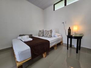 a white room with a bed and a table at BnB Ecostay in San José