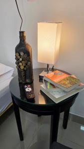 a table with a lamp and a bottle on it at BnB Ecostay in San José +19 photos