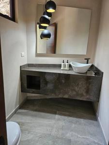 a bathroom with a sink and a mirror at Villa en el Bosque de Avándaro - Vista al Lago in Valle de Bravo +33 photos