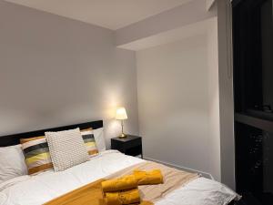 a bedroom with a bed with yellow towels on it at Sky One Serenity in Box Hill +23 photos