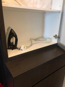 ein Telefon, das auf einem Regal in einem Schrank steht in der Unterkunft LA VISTA BANGI Homestay in Bangi