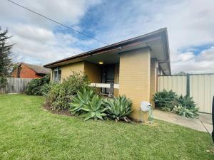 a house in a yard with plants in front of it at D118 Cawood Family Stay in Sunshine