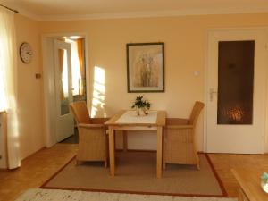 a dining room with a wooden table and chairs at Ferienwohnung Lehmann in Bad Endorf