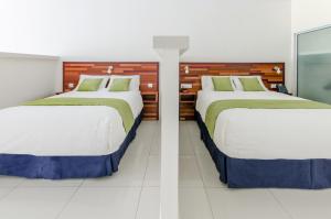 Łóżko lub łóżka w pokoju w obiekcie Hotel Babylon