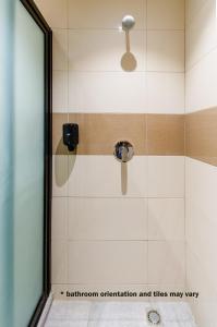 y baño con ducha con cabezal de ducha. en Hotel Babylon en Paramaribo