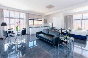 a living room with a couch and a bed at Hotel Babylon in Paramaribo