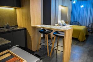 a room with a bed and a table with two stools at Home Rosario in Rosario