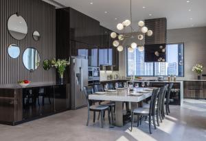 a kitchen and dining room with a table and chairs at Fraser Residence Hanoi in Hanoi