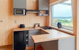 a small kitchen with a counter and a window at 2 Bedroom Beautiful Home In Brzuze in Brzuze