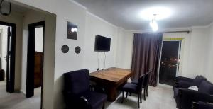 a dining room with a wooden table and chairs at Aqua View Resort North Coastالساحل الشمالي K91 in El Alamein