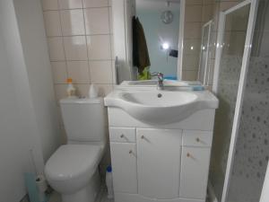 a white bathroom with a toilet and a sink at Le Barcarès - Villa T3 Coquette - Résidence Calme - Proche Plage, Port, et Village - Parking Privé - FR-1-799-38 in Le Barcarès +9 photos