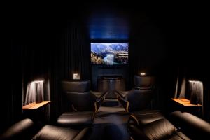 a waiting room with leather chairs and a television at Luxe Hobart Villa - Boxwood in Hobart