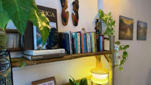 a book shelf with books on top of it at Baan YentaFo - Pink House 2nd floor in Chinatown
