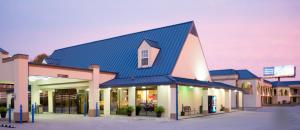 a blue and white building with a blue sky at Days Inn by Wyndham Owensboro in Owensboro